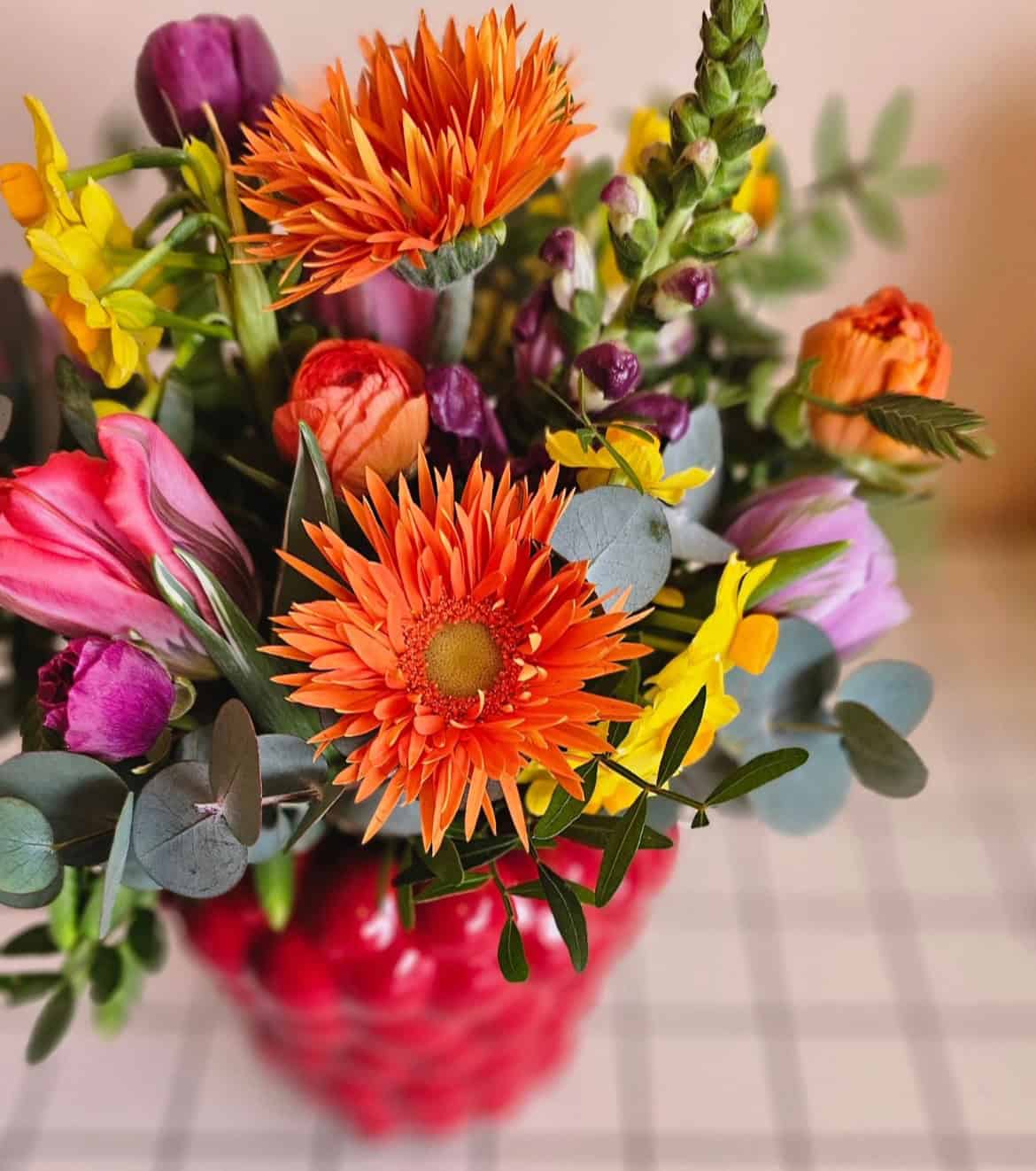 Summer flowers in a red vase