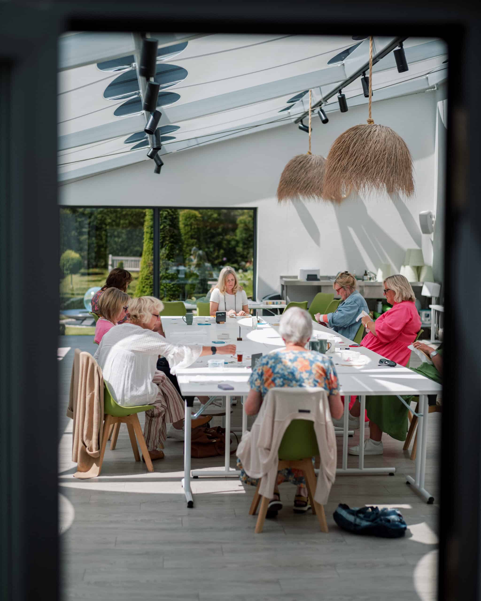 Embroidery workshop participants learning with a tutor